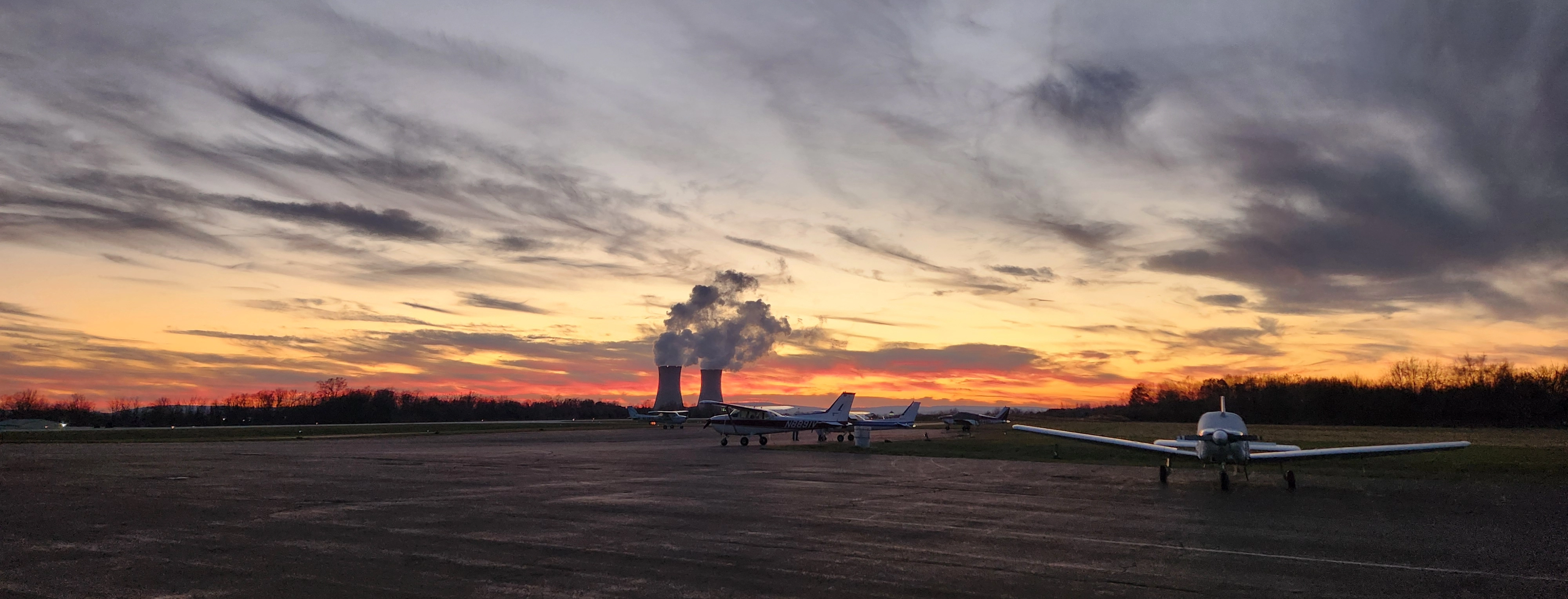Pitcairn Flight Academy training aircraft landed under the sunset with a view of the Philadelphia skyline in the background